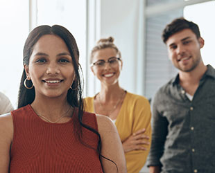 Picture of several smiling team members in business casual attire