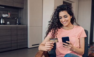 woman activating her card using her phone