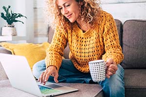 Woman sending email on a laptop