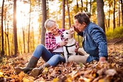 Retired Couple In the Woods with their dog